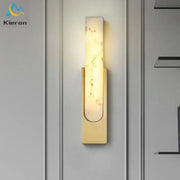 Modern gold cloud stone led wall light featuring a gold-toned rectangular marble-like panel emitting warm light