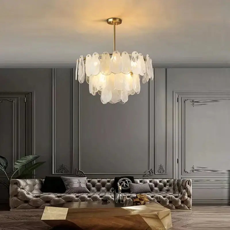 A modern gold cloudy glass chandelier with translucent layered petals from decorbites cloudy glass collection for living room lighting