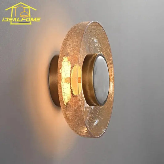 Modern gold wall lamp with decorbites cracked glass amber shade and circular frosted lens for bedroom lighting
