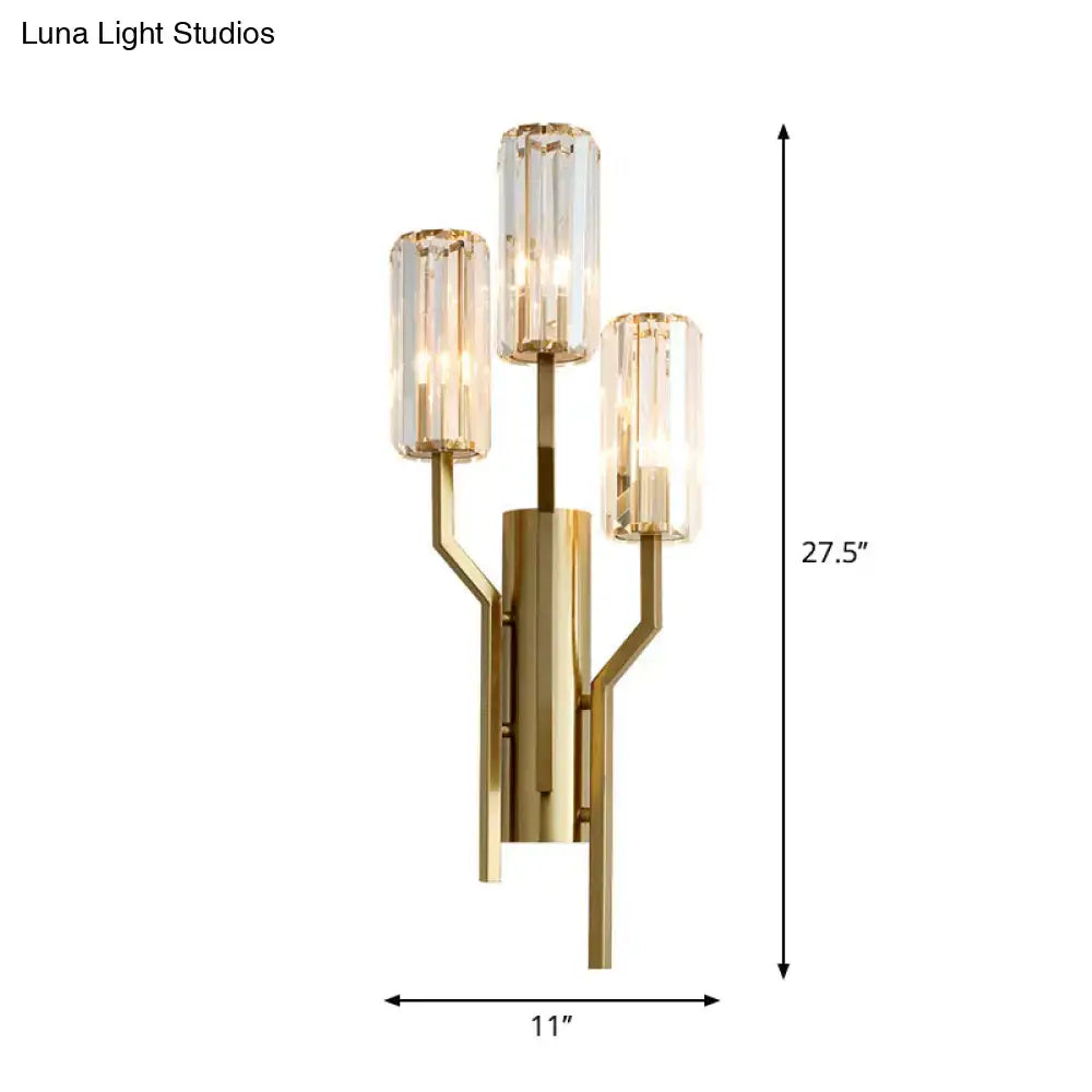 Modern gold crooked arm wall lamp featuring three faceted crystal cylinders for elegant living room lighting