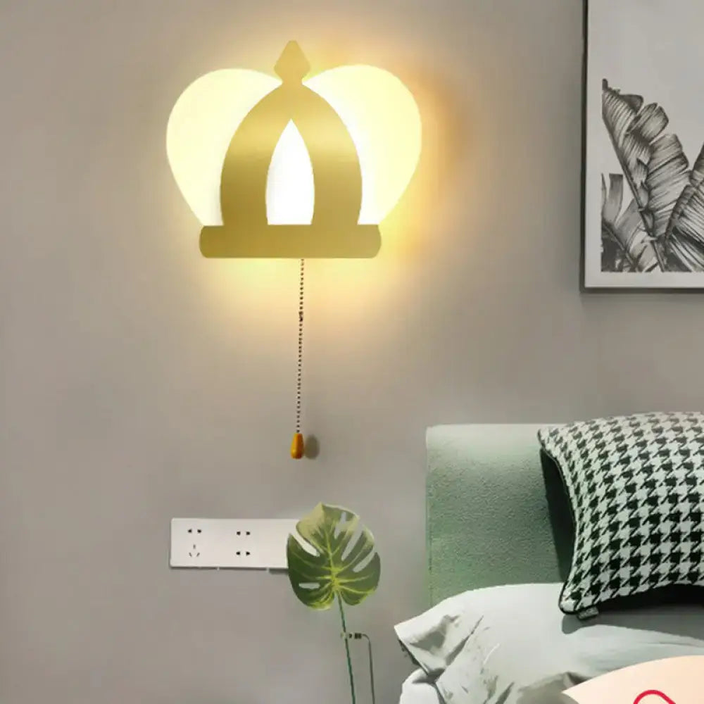 Modern gold crown wall lamp with warm glowing light and pull chain for elegant wall lighting in bedrooms