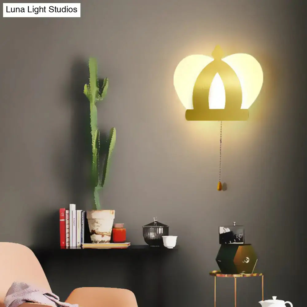 Modern gold crown wall lamp featuring warm glowing light and pull chain for elegant wall lighting in bedroom