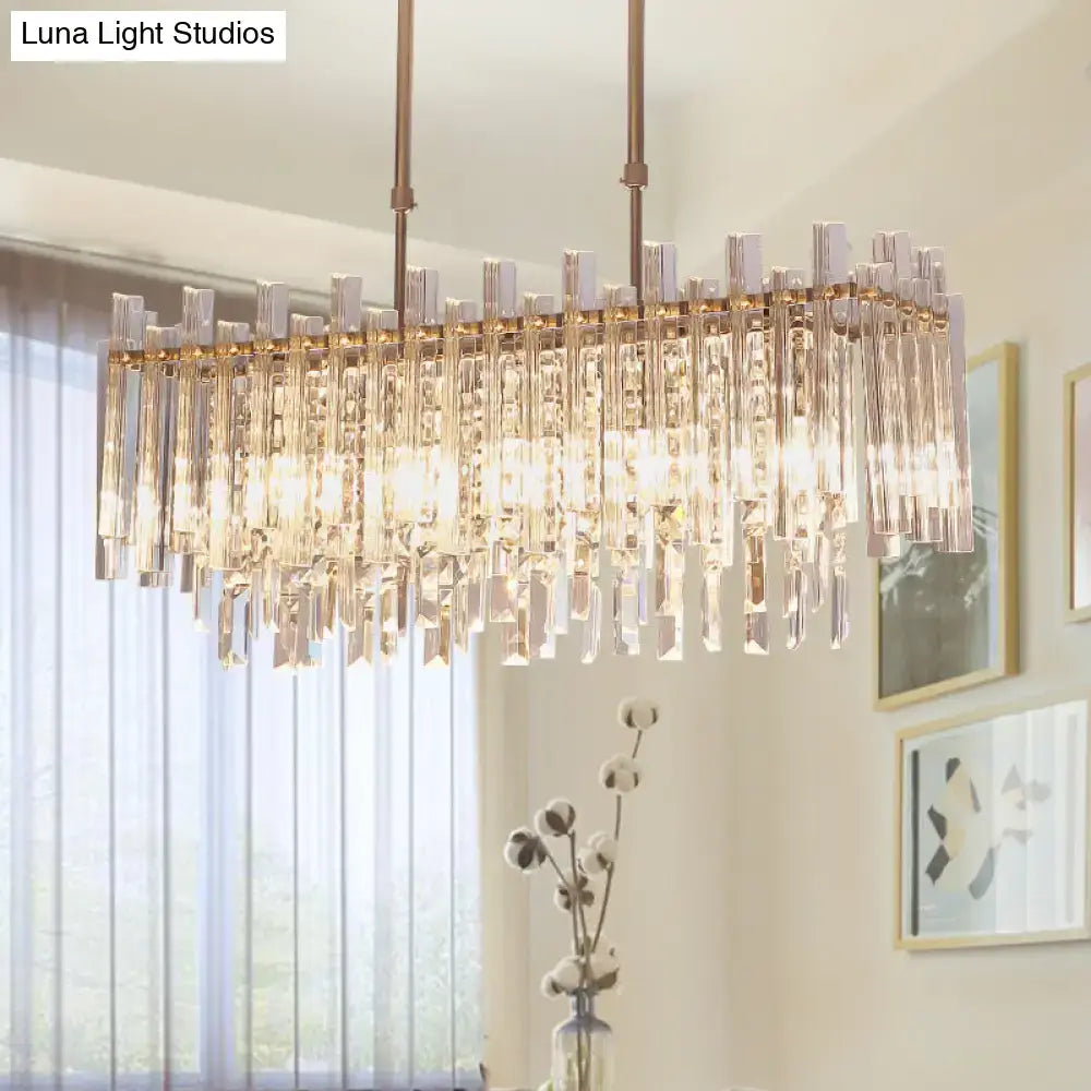 A modern gold crystal 5 light fixture dining room chandelier with bronze frame and cascading clear crystal prisms 220v-240v