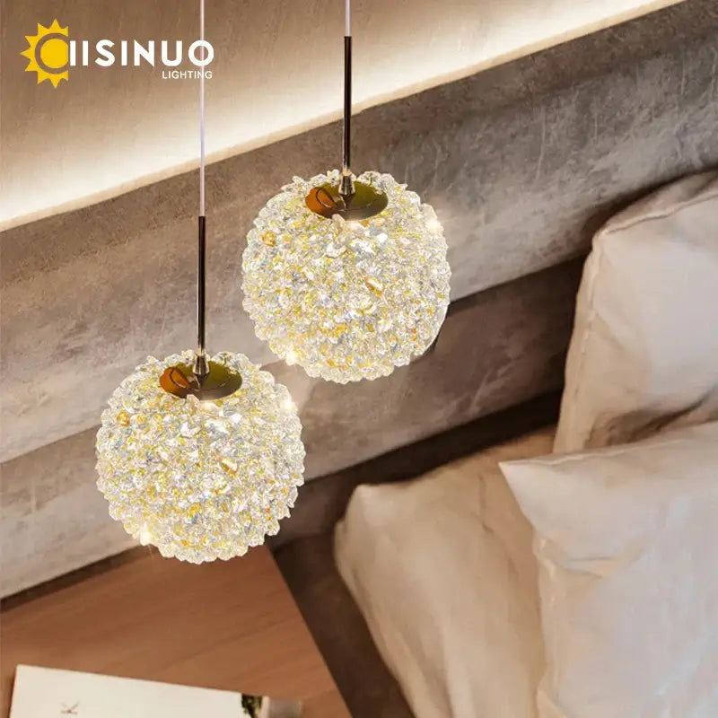 Two modern gold crystal ball pendant lights with clear faceted glass crystals for elegant bedroom decorbites pendant light