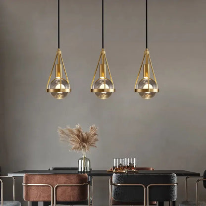 Three modern gold crystal ball pendant lights with metal frames and clear glass globes for dining room decorbites crystal ball