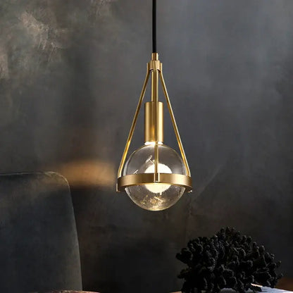 Modern gold crystal ball pendant light with clear glass globe and minimalist metal frame for dining room decorbites pendant lights