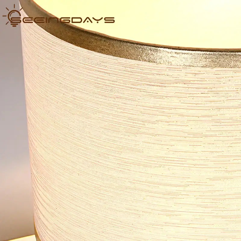 Modern gold crystal ball table lamp with cream fabric textured shade and metallic gold rim for bedroom use