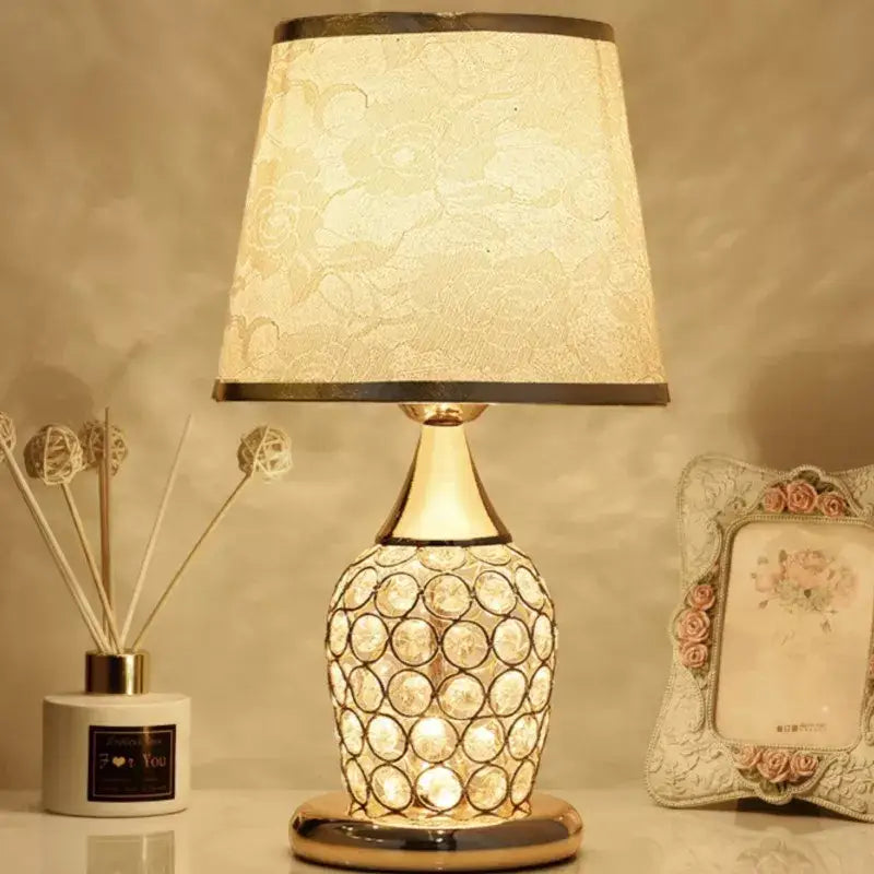 Modern gold crystal bedroom table lamp with a gold-toned base and off-white lace-patterned shade for decorbites crystal bedroom decor