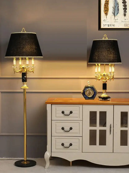 Modern gold crystal black table lamp featuring a gold-finished chandelier style with black textured shade and candle bulbs