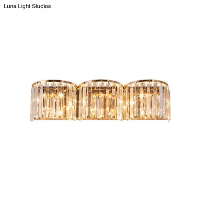 Modern gold crystal block wall light with three cylindrical faceted glass prisms refracting warm light 220v-240v