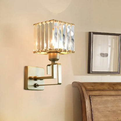 Modern gold crystal block wall sconce with brass finish and faceted crystal shade for bedroom lighting
