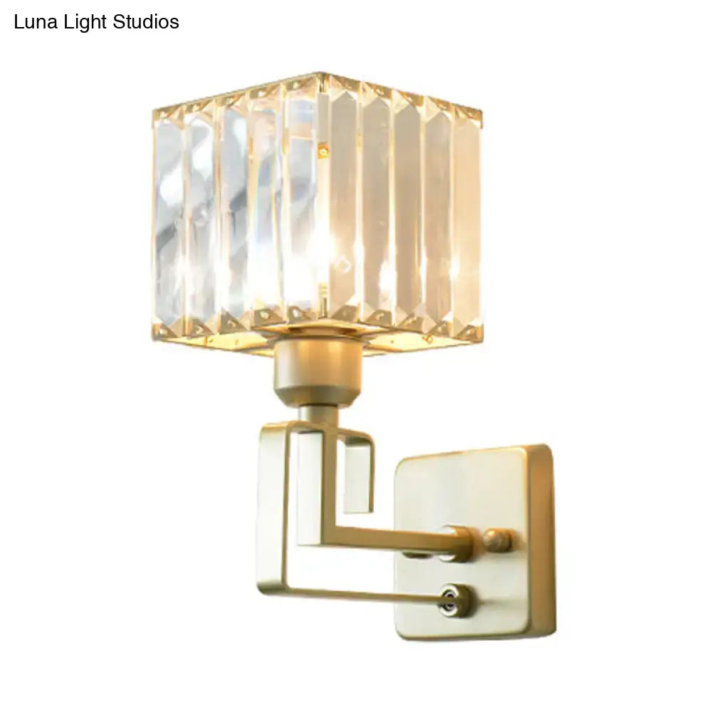 Modern gold crystal block wall sconce with a square faceted crystal block shade and brushed brass arms for bedroom lighting