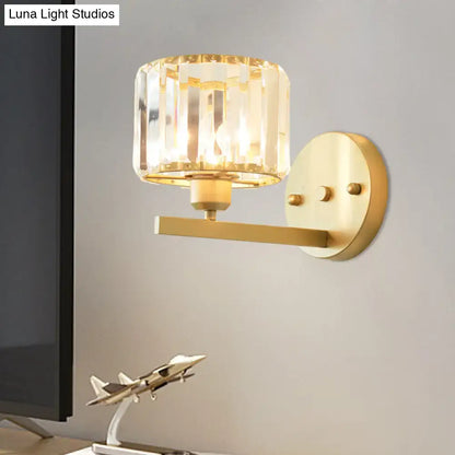 Modern gold crystal block wall sconce with faceted crystal shade for elegant bedroom lighting on a block wall