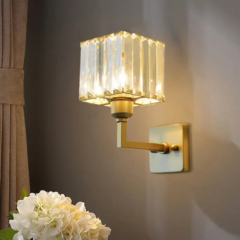 Modern gold crystal block wall sconce featuring a faceted crystal block shade for elegant bedroom lighting