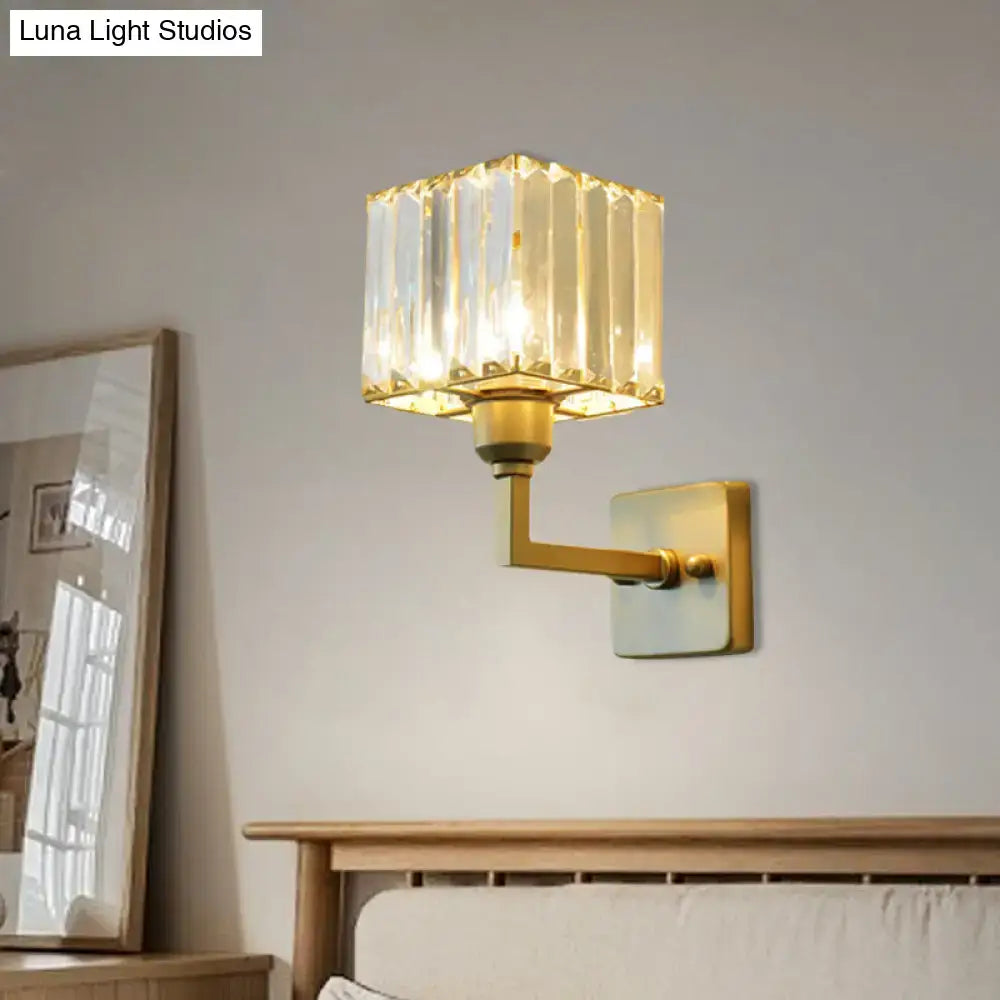 Modern gold crystal block wall sconce with a faceted crystal block shade for elegant bedroom lighting