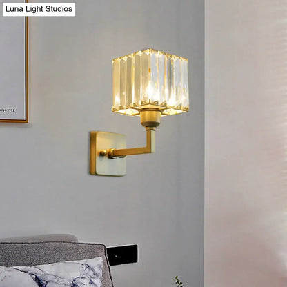 Modern gold crystal block wall sconce with faceted crystal shade for elegant bedroom lighting on block wall