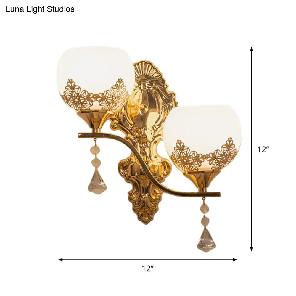 Modern gold crystal bowl wall sconce with two frosted glass shades floral cutouts and crystal teardrop pendants for living room