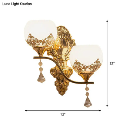 Modern gold crystal bowl wall sconce with two frosted glass shades floral cutouts and crystal teardrop pendants for living room