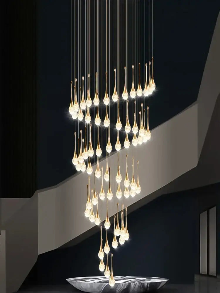 Modern gold crystal bubble chandelier with teardrop pendant and warm glowing lights above a sleek silver bowl decorbites crystal bubble