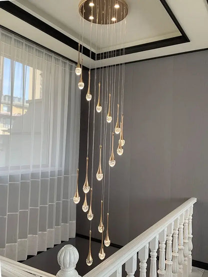 Modern gold crystal bubble chandelier teardrop pendant with crystal accents hanging from circular ceiling fixture