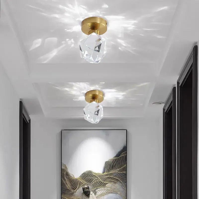Modern gold crystal ceiling lights featuring faceted crystal pendants with gold-finished bases for bedroom use