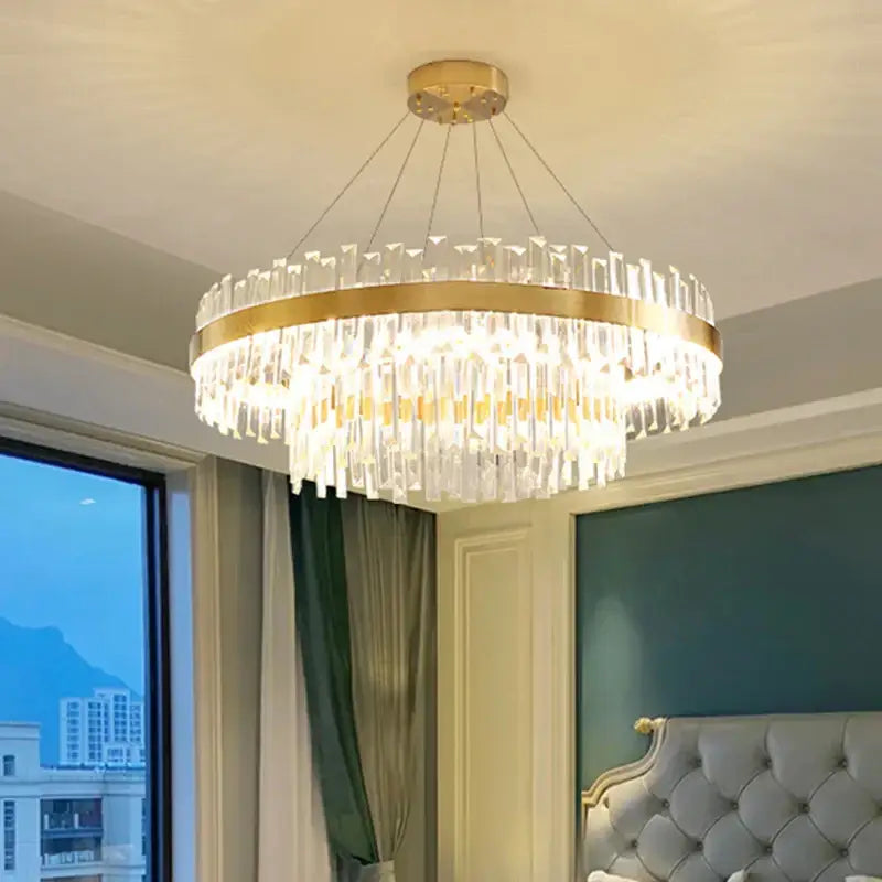 A decorbites circular crystal chandelier with gold-toned metal frame and cascading prisms for dining room lighting fixture