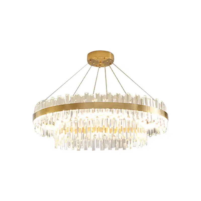 Modern gold crystal chandelier lighting fixture with cascaded crystal prisms and decorbites circular brass frame for dining room