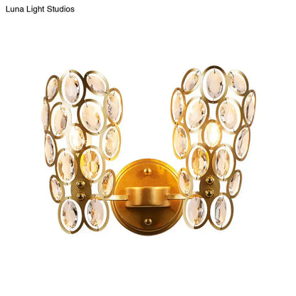 Modern gold crystal circles wall light featuring gold-toned sconce with cascading oval crystals for bedroom use