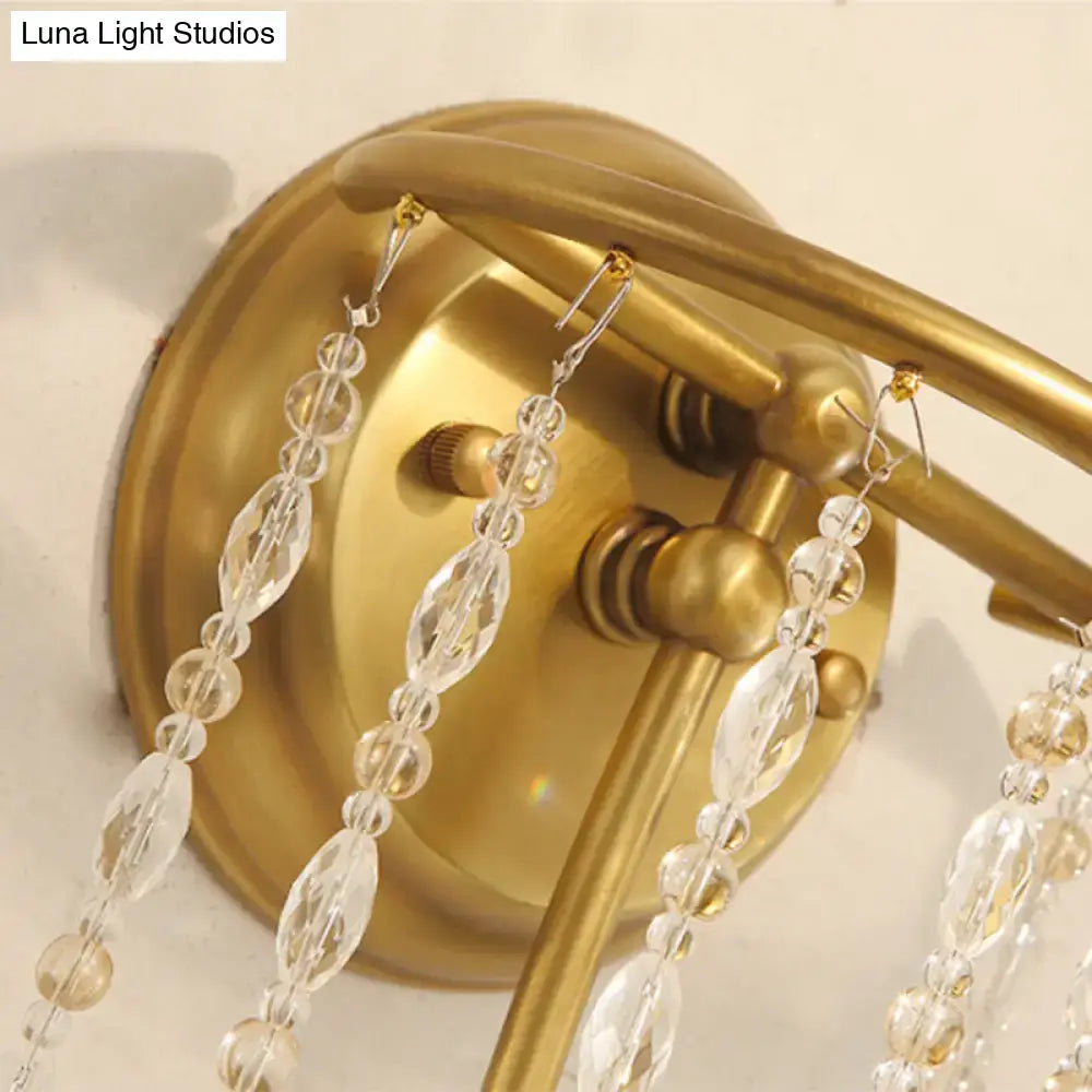 Brass-finished wall lamp with dangling crystal beads designed as a modern gold corridor wall lamp for bedroom lighting