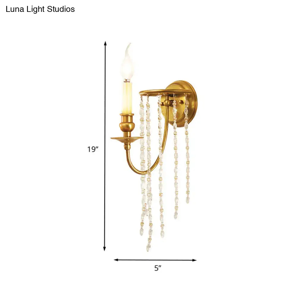 Modern gold crystal corridor wall lamp featuring a gold-finished wall lamp with a single candle-style bulb and clear crystal beads