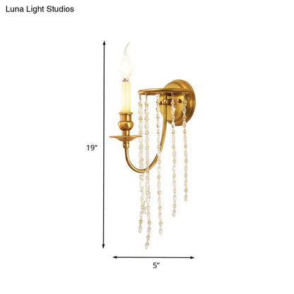 Modern gold crystal corridor wall lamp featuring a gold-finished wall lamp with a single candle-style bulb and clear crystal beads