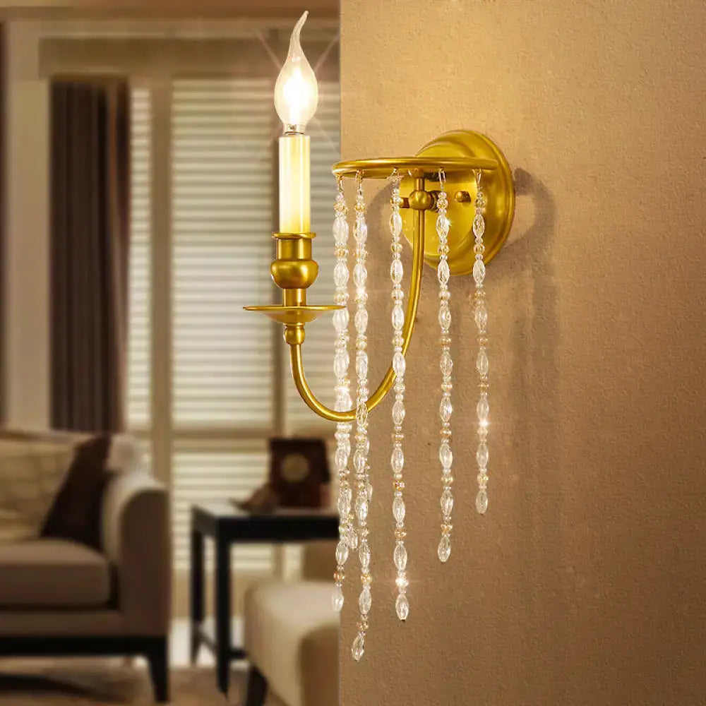 Modern gold crystal corridor wall lamp features a gold-toned wall sconce with dangling crystals and candle-style bulb lights corridor wall