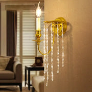 Modern gold crystal corridor wall lamp features a gold-toned wall sconce with dangling crystals and candle-style bulb lights corridor wall