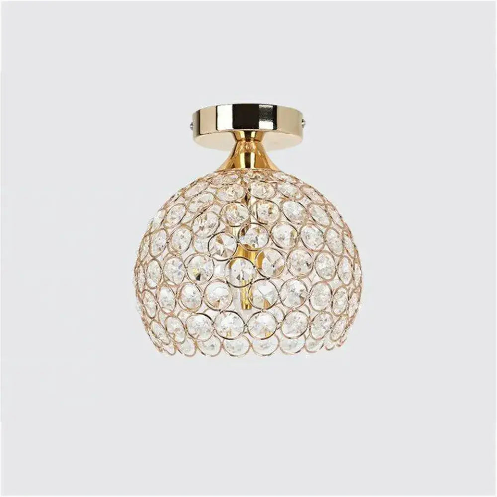 Modern gold crystal diamond ceiling light with spherical faceted crystals and gold-toned metal base for dining room
