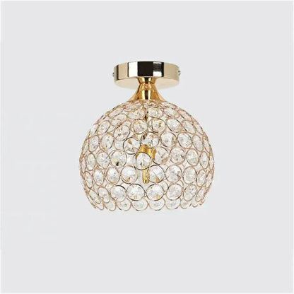 Modern gold crystal diamond ceiling light with spherical faceted crystals and gold-toned metal base for dining room