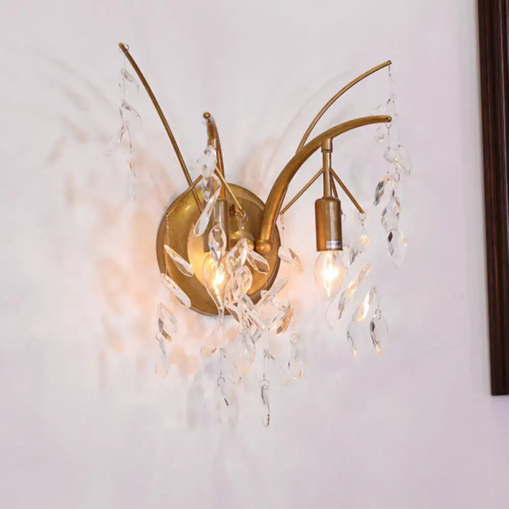 Modern gold wall sconce with two curved arms and dangling crystal droplets for living room branch light