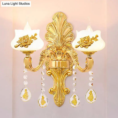 Modern gold crystal droplet wall mount light with ornate gold floral details and frosted glass shades for bedroom use