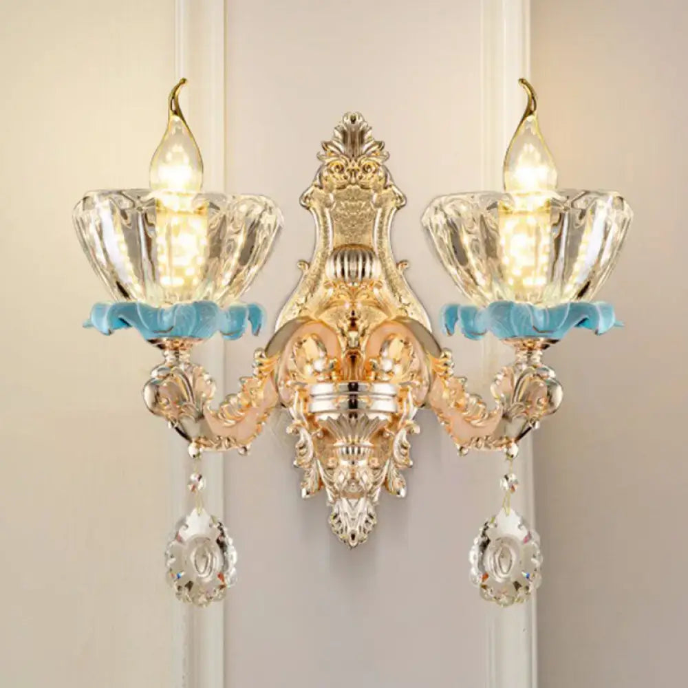 Modern gold wall mount light featuring ornate crystal glass shades with light blue decorative accents for bedroom use