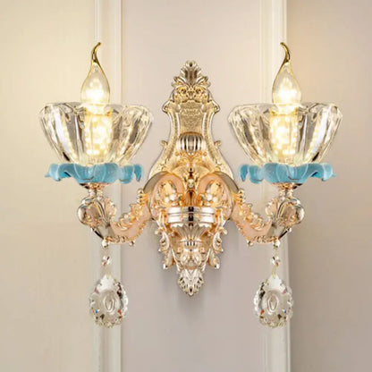 Modern gold wall mount light featuring ornate crystal glass shades with light blue decorative accents for bedroom use