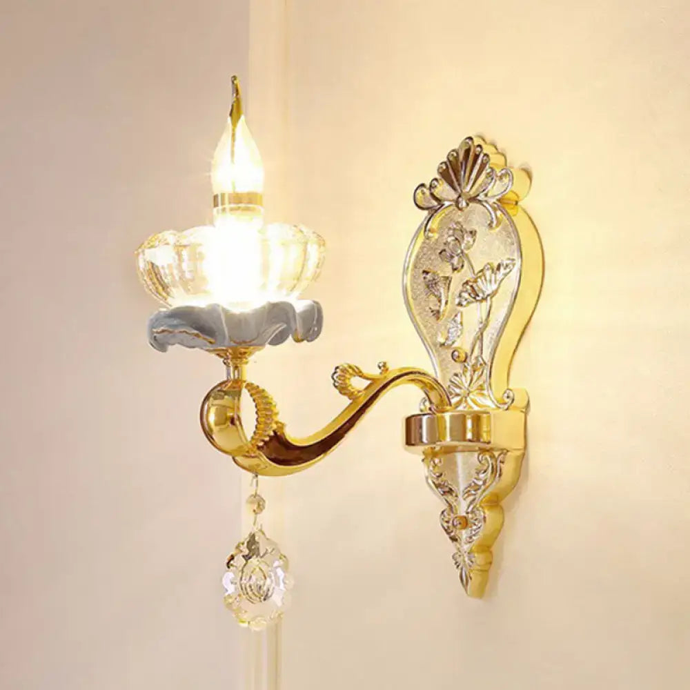 Gold-toned modern wall mount light with ornate floral shell design frosted glass candle holder and crystal droplet detail