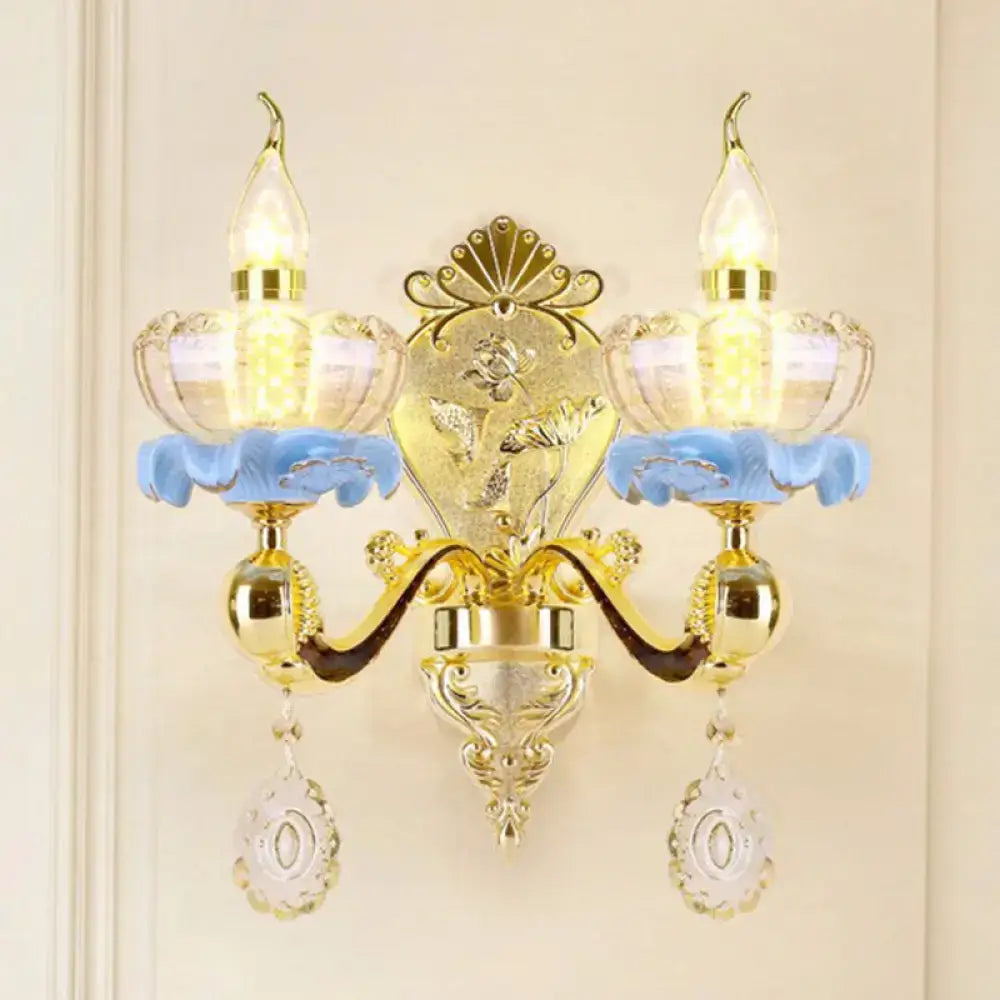 Modern gold crystal droplet wall mount light with ornate design, blue floral accents, and two glass candle bulbs
