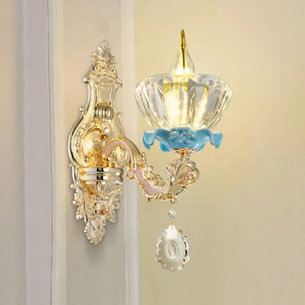 Modern gold wall mount light with ornate crystal droplet design and blue enamel accents for bedroom use