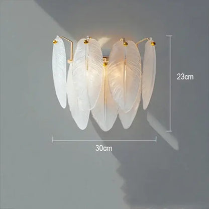 Elegant white feather-shaped wall sconce with gold-toned accents for decorbites crystal feather chandelier lighting