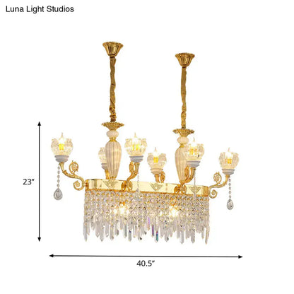 Gold-toned decorbites crystal floral island pendant lamp with ornate arms and candle-style bulb base dining room light fixture