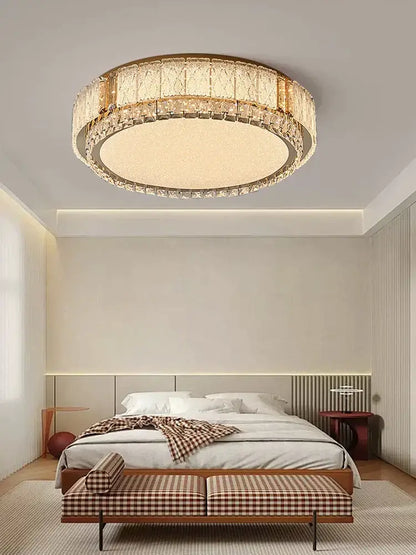 Modern gold light fixture with decorbites crystal glass tiers and illuminated central panel for living room decor
