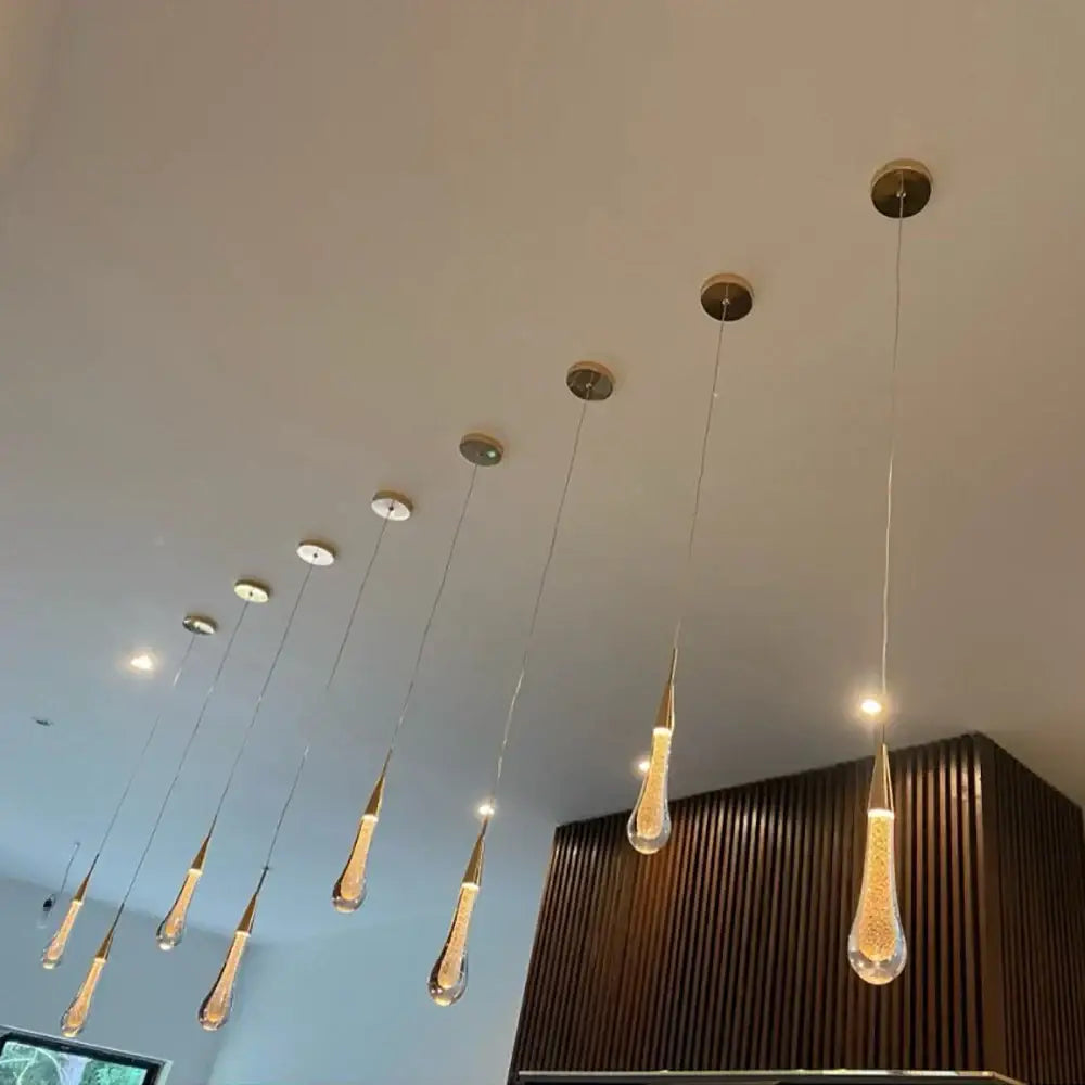 Modern gold crystal glass led pendant lights featuring a teardrop shape with brass accents for dining room decorbites crystal glass
