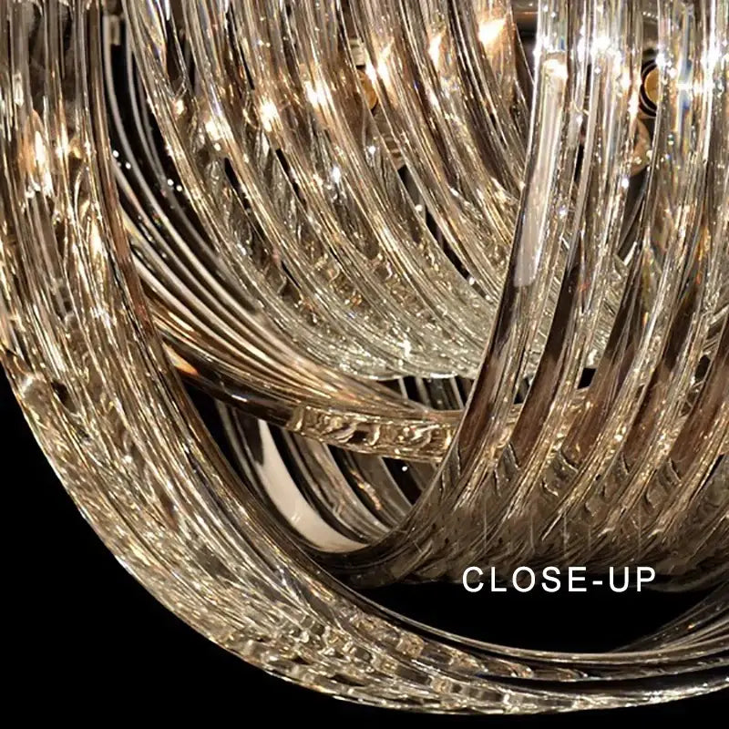 A modern gold crystal glass pendant lights dining room chandelier with intricate twisted glass arms reflecting light