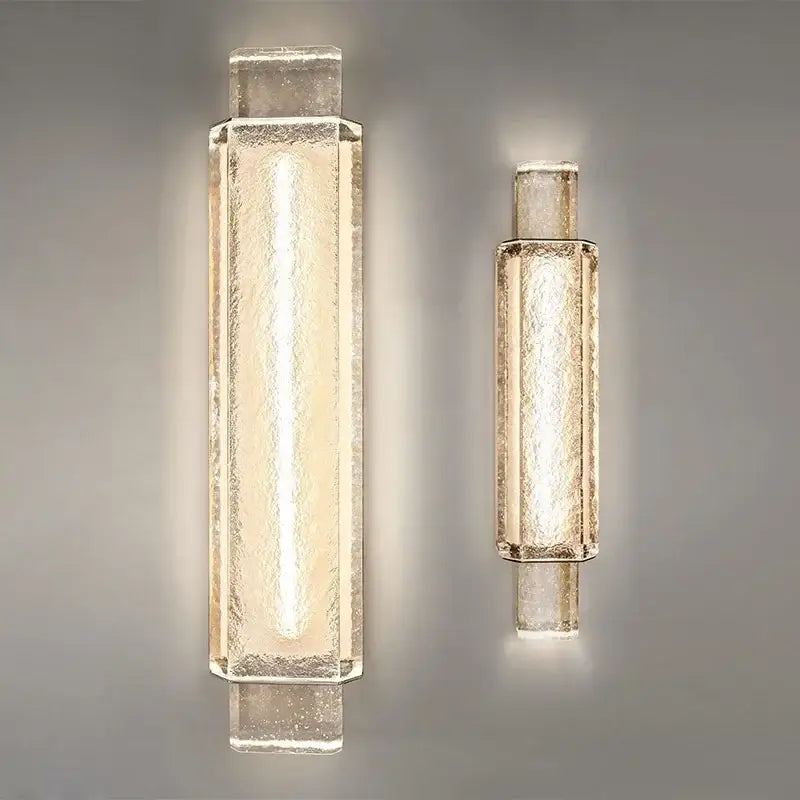 Two modern gold wall lamps with crystal glass shades featuring a warm glow for bedroom wall lights