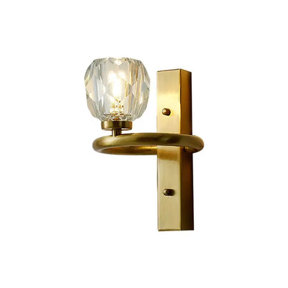 A sleek modern gold brass wall lamp with a faceted crystal globe for bedroom lighting 110v-120v