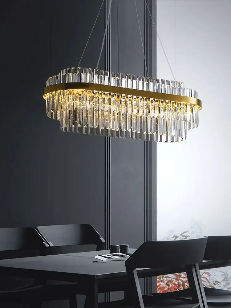 Modern gold crystal hanging lamp with gold-toned oval frame and cascading clear prisms for living room decorbites crystal hanging